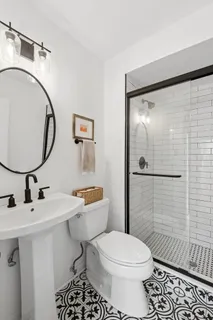 a bathroom with a sink toilet and shower