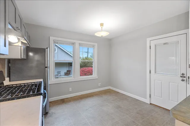 an empty room with windows and entrance