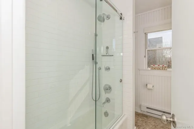 a bathroom with a shower and a glass door