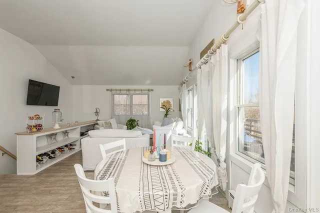 a view of a dining room with furniture window and outside view