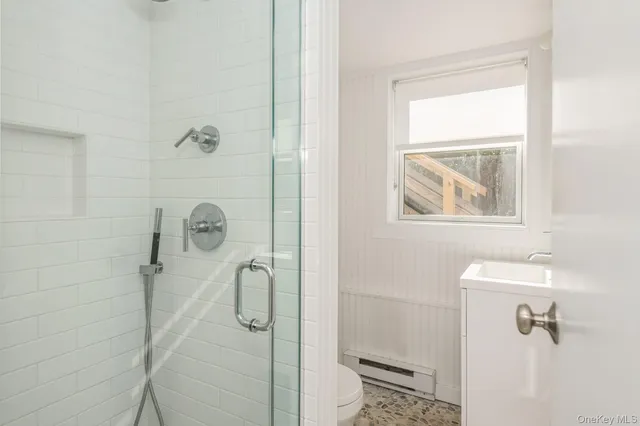 a bathroom with a glass shower door