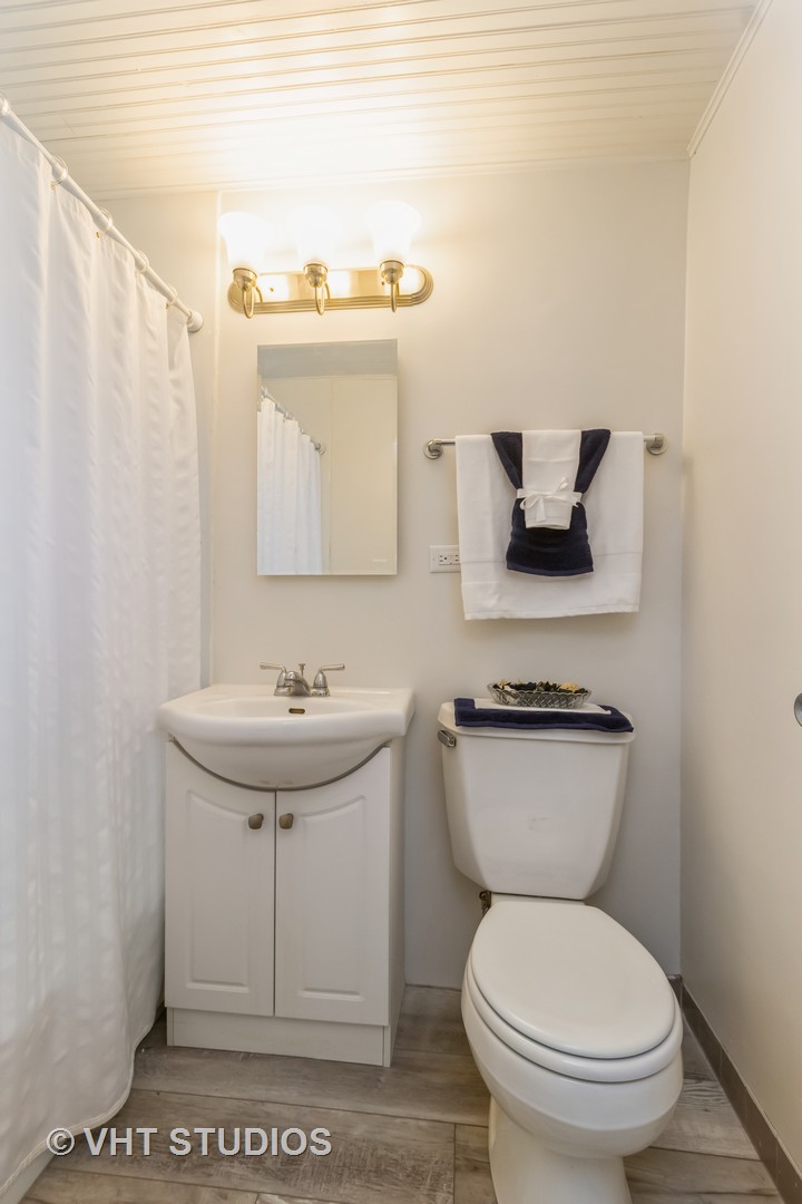 11 Dunlap Road Park Forest, IL 60466 - Photo 9 of 12 a bathroom with a toilet a sink and mirror