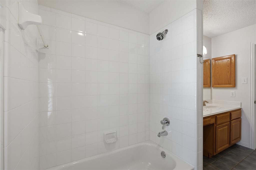 14584 Blueberry Court Addison, TX 75001 - Photo 30 of 40 a bathroom with a bathtub and a sink