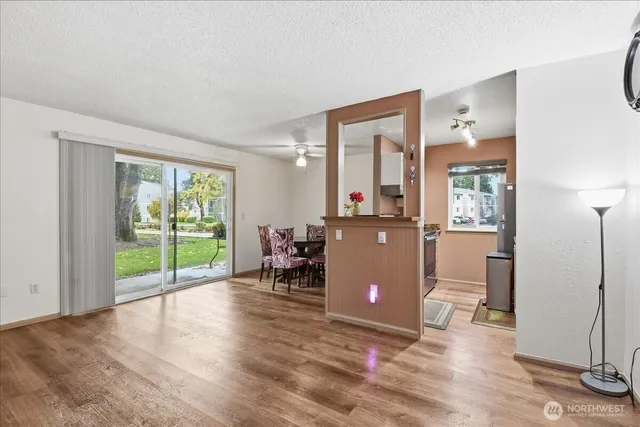 a view of a livingroom with wooden floor and a flat screen tv