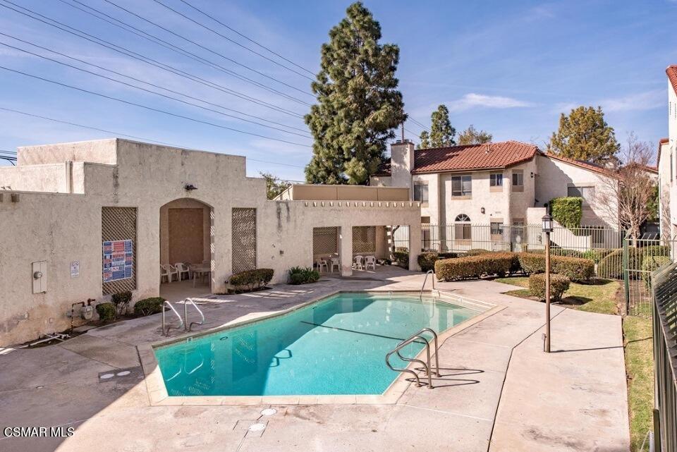 3306 Darby Street, Unit 402 Simi Valley, CA 93063 - Photo 21 of 31 a view of a house with backyard sitting area and swimming pool