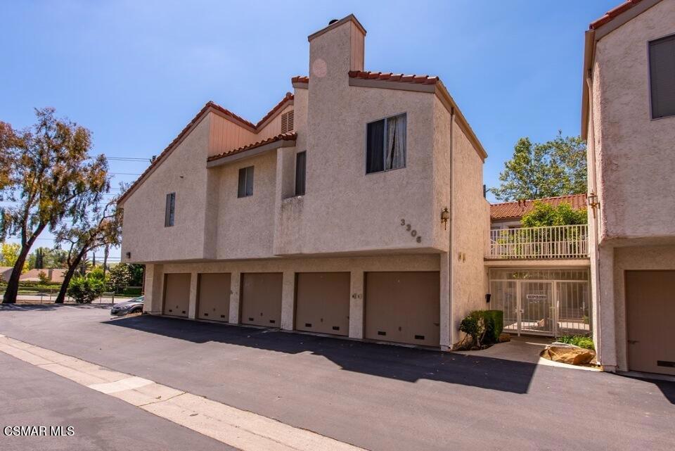 3306 Darby Street, Unit 402 Simi Valley, CA 93063 - Photo 26 of 31 a front view of a house with a yard