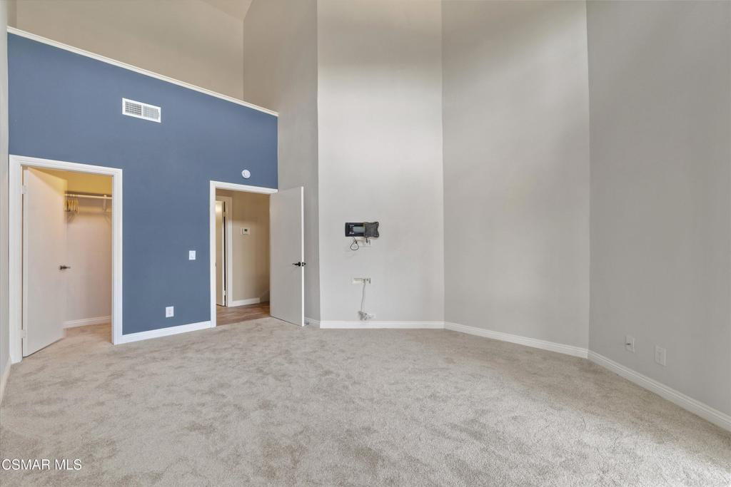 3306 Darby Street, Unit 402 Simi Valley, CA 93063 - Photo 9 of 31 an empty room with closet and mirror