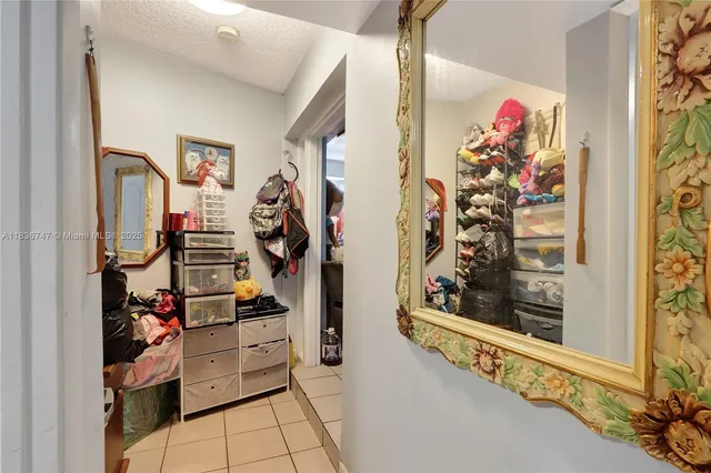 a kitchen with a refrigerator and white cabinets
