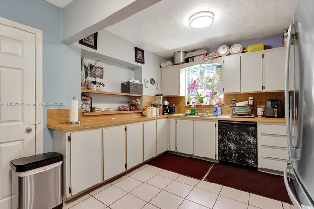 a kitchen with granite countertop cabinets and steel stainless steel appliances