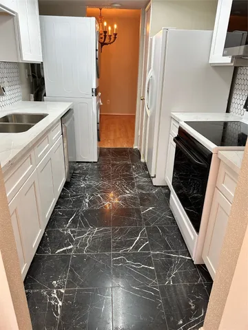 a kitchen with a sink a stove and refrigerator