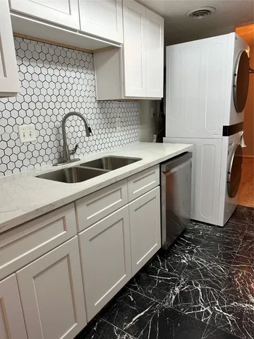 a close view of a sink and dishwasher in a kitchen