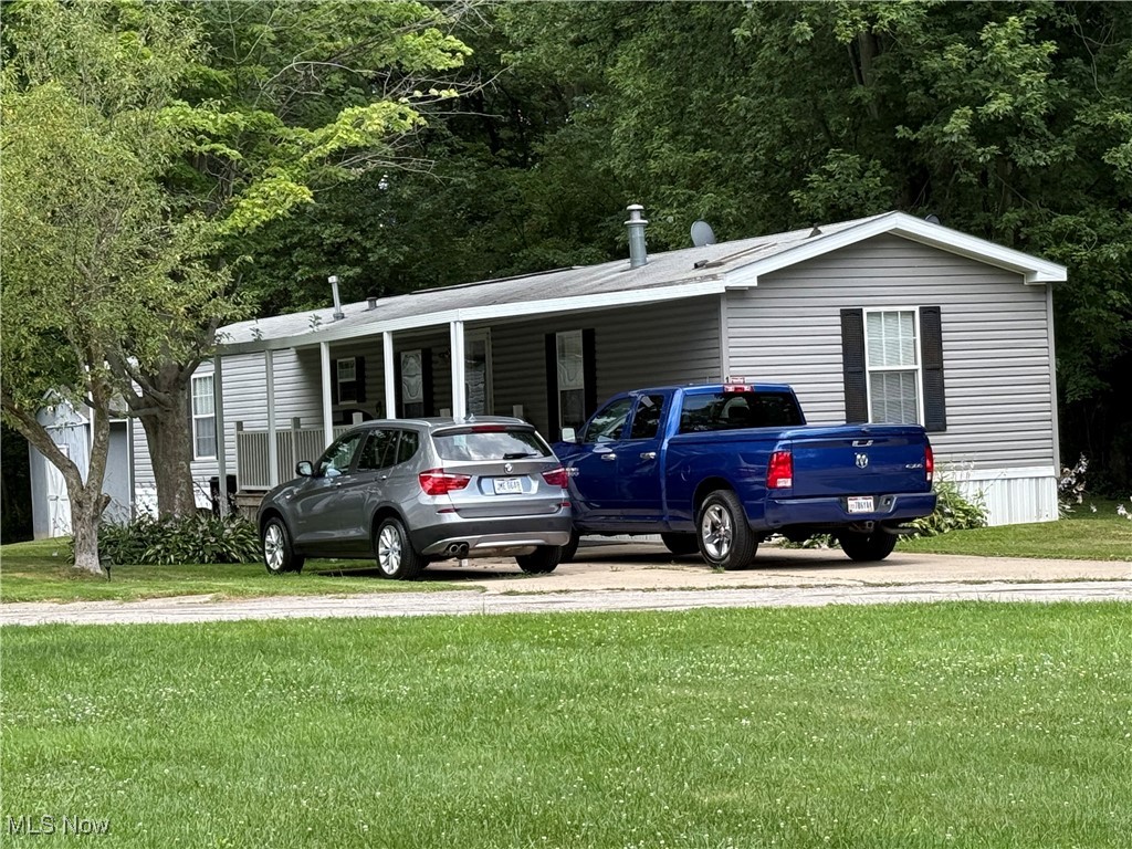 3925 North Ridge Road East Ashtabula, OH 44004 - Photo 1 of 19 View of car parking featuring a carport and driveway