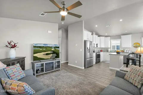 a living room with furniture and a wooden floor