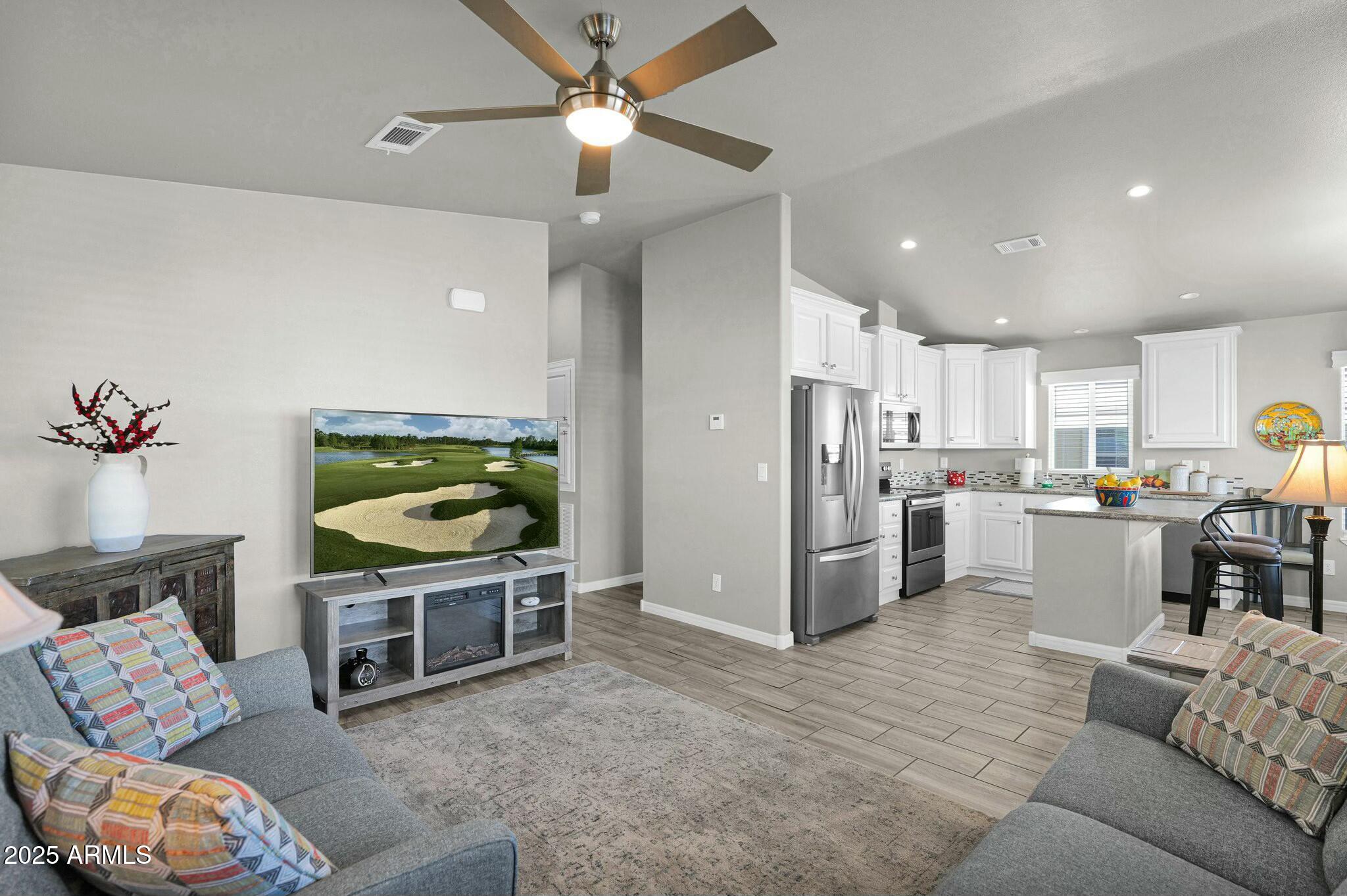 650 North Hawes Road, Unit 3505 Mesa, AZ 85207 - Photo 13 of 46 a living room with furniture and a wooden floor