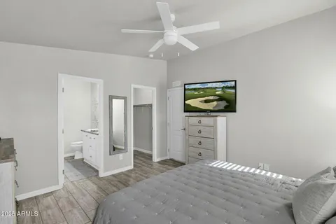 a bedroom with a bed and a flat screen tv