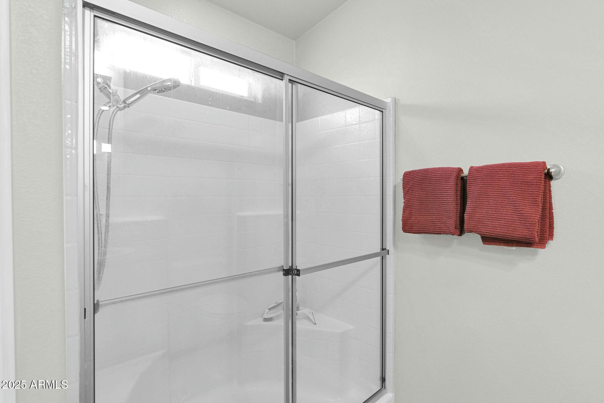 650 North Hawes Road, Unit 3505 Mesa, AZ 85207 - Photo 19 of 46 a bathroom with a glass shower door