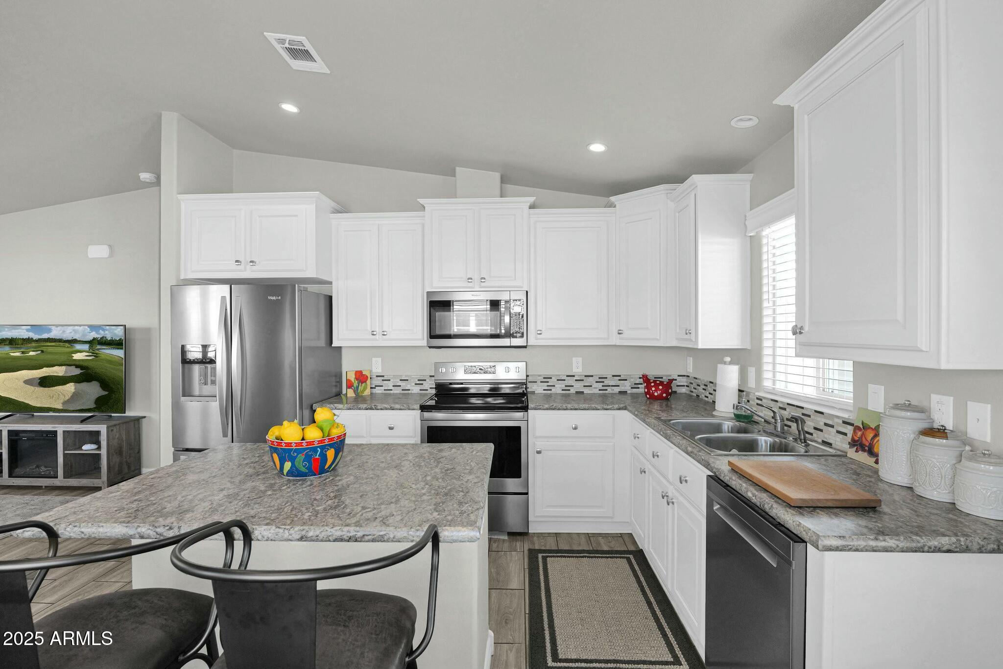 650 North Hawes Road, Unit 3505 Mesa, AZ 85207 - Photo 8 of 46 a kitchen that has a sink cabinets and stainless steel appliances