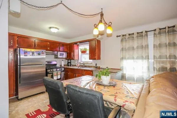 a view of a dining room with furniture a chandelier and wooden floor