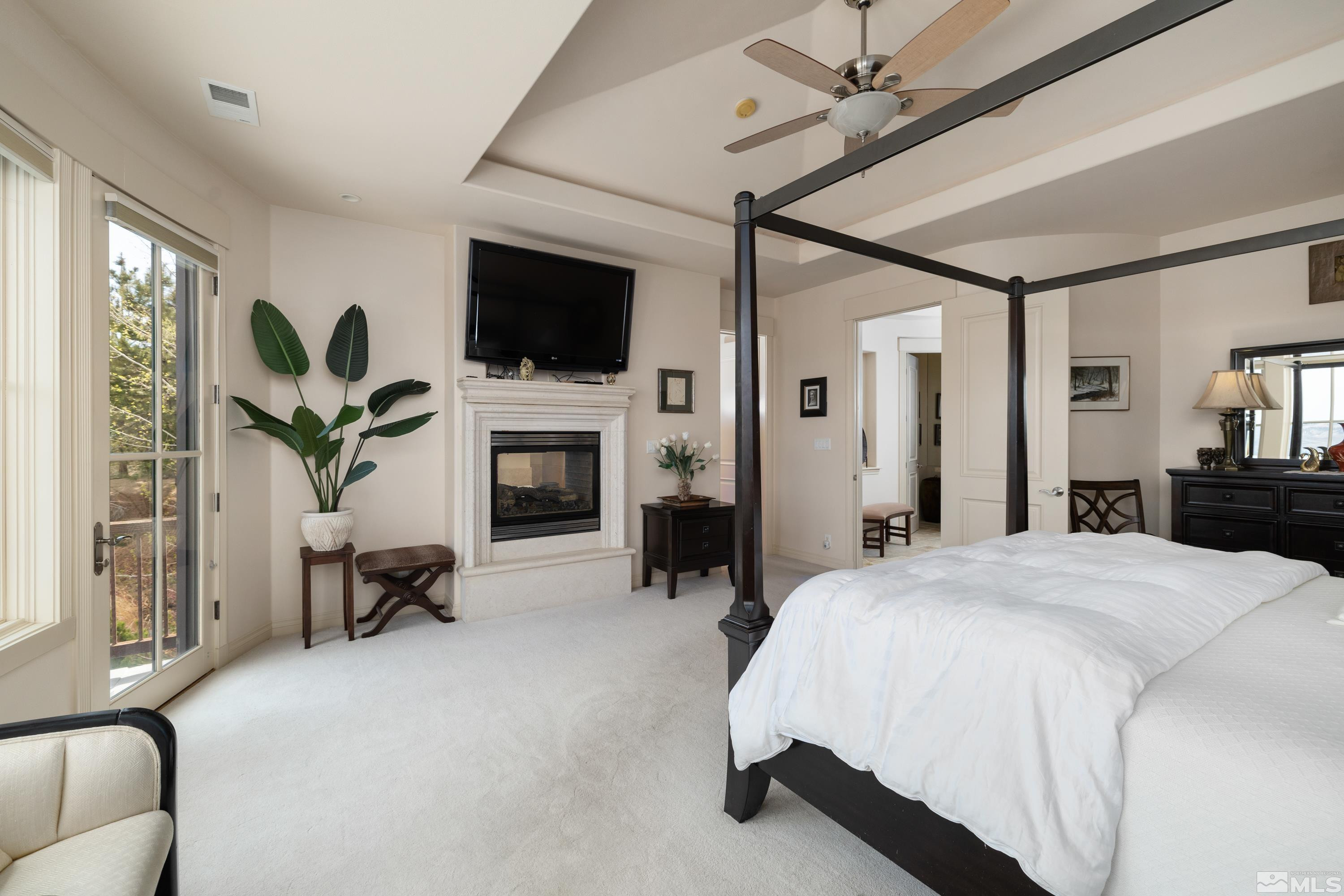 2440 Mountain Spirit Trail Reno, NV 89523 - Photo 14 of 34 a spacious bedroom with a bed and a flat screen tv