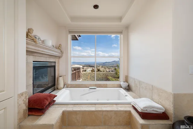 a bathroom with a tub and window