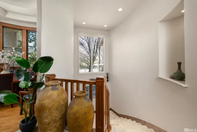 a view of entryway and hall with wooden floor