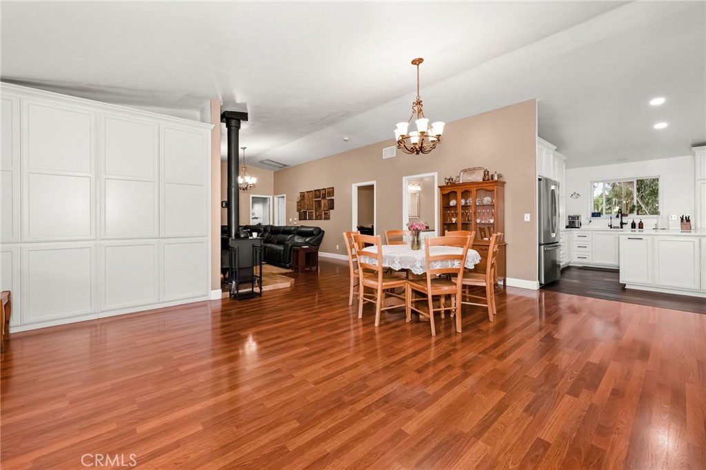 2728 Pentz Road Oroville, CA 95965 - Photo 11 of 52 a view of a dining room and livingroom with furniture wooden floor a chandelier