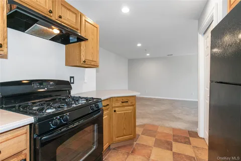 a kitchen with granite countertop a stove and a shower