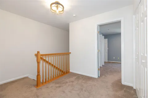 a view of a hallway to a window