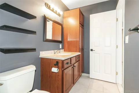 a bathroom with a sink a toilet and vanity