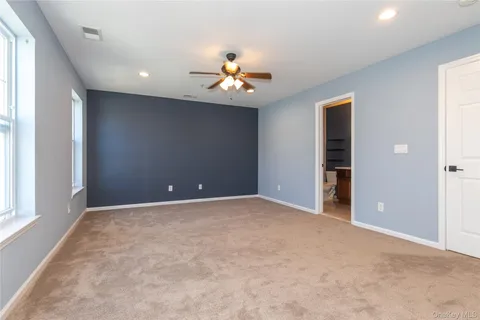 an empty room with closet and a window