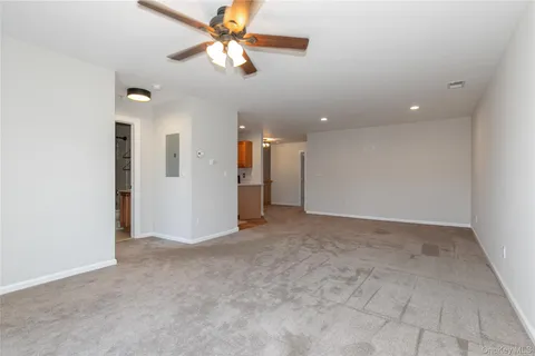 an empty room with fan and a ceiling fan