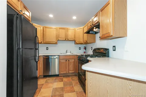 a kitchen with a sink a refrigerator and cabinets
