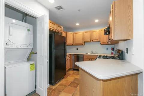 a kitchen with a sink a counter appliances and cabinets
