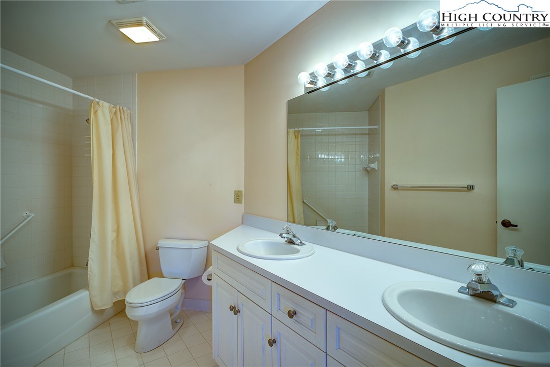 151 Deer Valley Drive, Unit 234 Boone, NC 28607 - Photo 11 of 22 a bathroom with a granite countertop sink toilet and shower