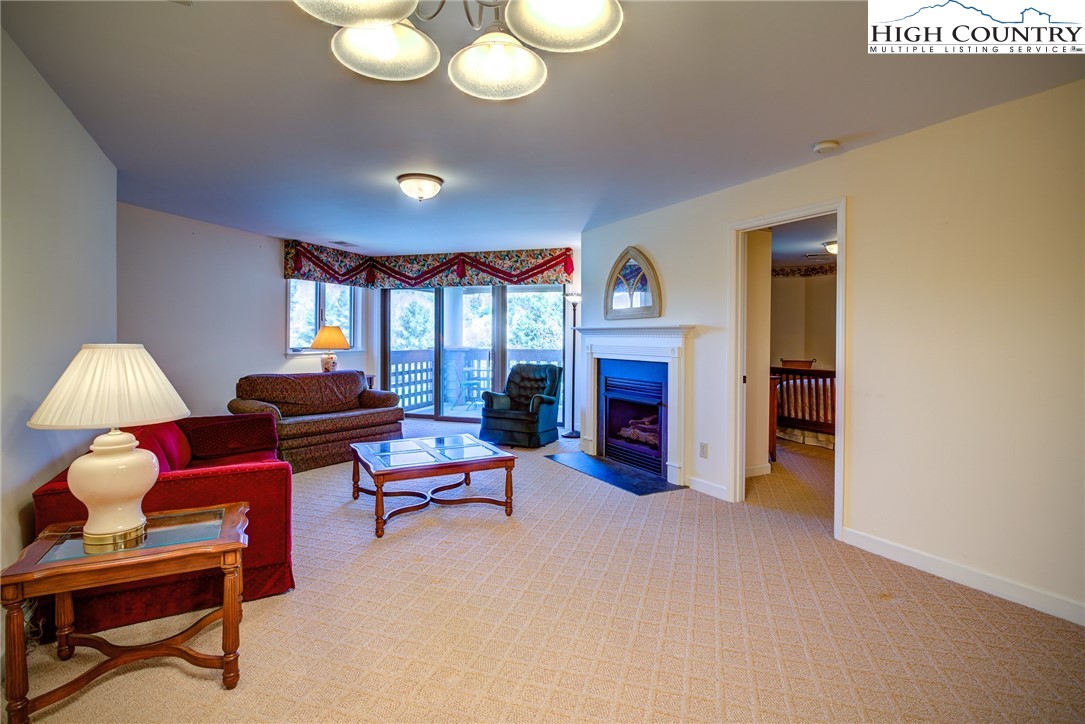 151 Deer Valley Drive, Unit 234 Boone, NC 28607 - Photo 4 of 22 a living room with furniture and a fireplace
