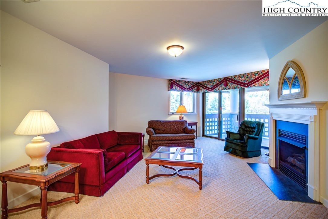 151 Deer Valley Drive, Unit 234 Boone, NC 28607 - Photo 5 of 22 a living room with furniture fireplace and a large window