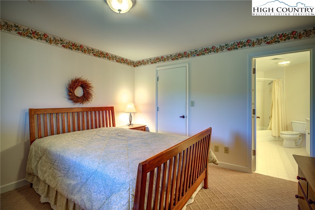 151 Deer Valley Drive, Unit 234 Boone, NC 28607 - Photo 10 of 22 a bedroom with bed and a window
