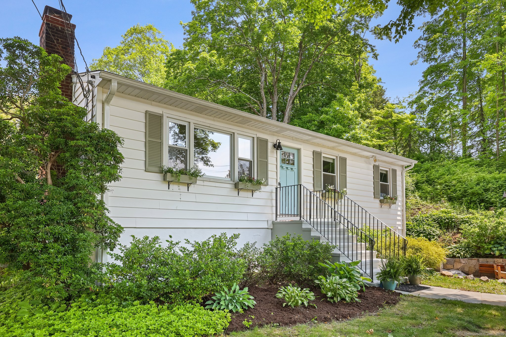a view of a house with a chairs in patio