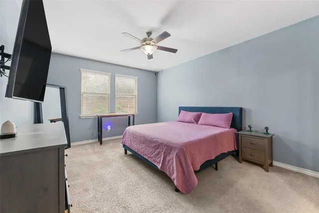 a bathroom with a granite countertop sink a toilet and a mirror