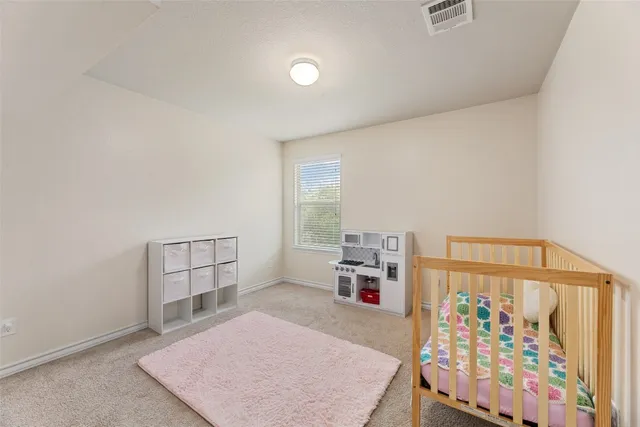 a bedroom with two beds and window