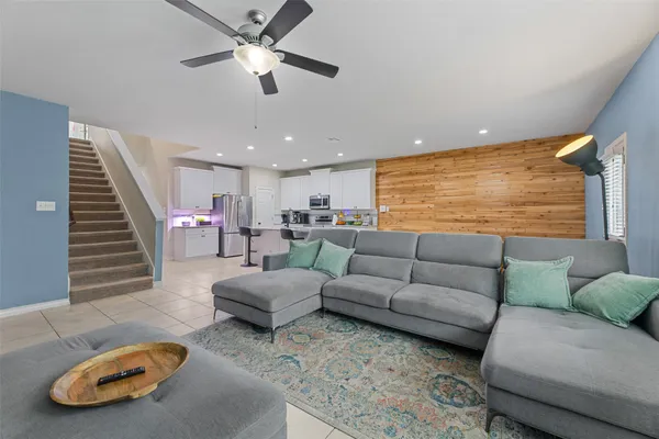 a living room with furniture and a flat screen tv