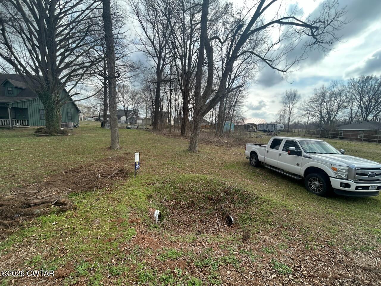 935 Magnolia Road Tiptonville, TN 38079 - Photo 3 of 4 a view of a backyard with a car parked