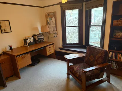 a living room with furniture gym equipment and a large window