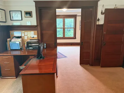 a view of a dining room with furniture a couch and wooden floor