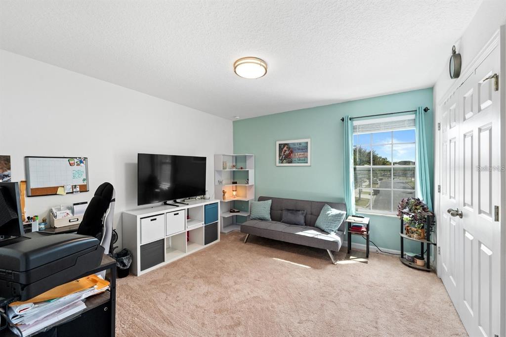 754 Andalusia Loop Davenport, FL 33837 - Photo 14 of 28 a living room with furniture and a flat screen tv