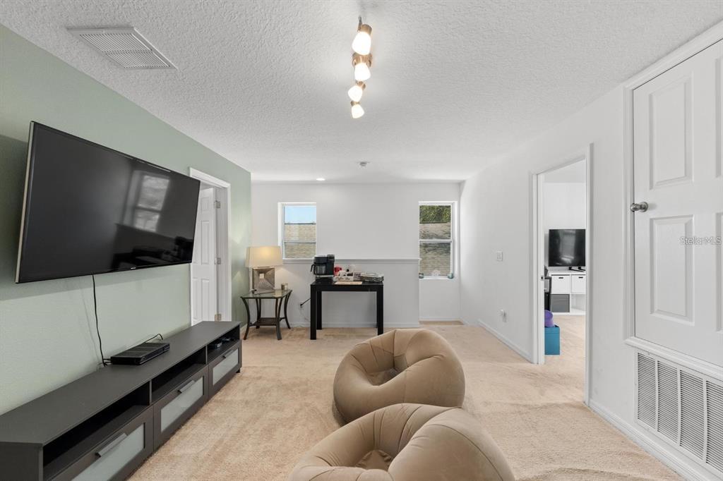 754 Andalusia Loop Davenport, FL 33837 - Photo 15 of 28 a living room with furniture and a flat screen tv