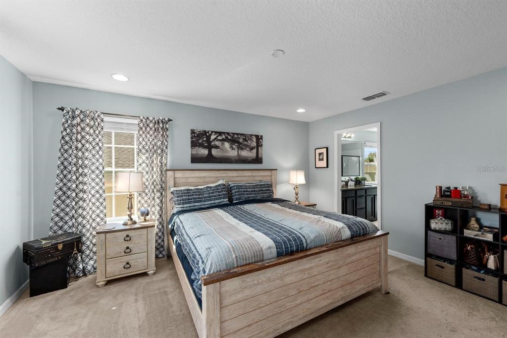 754 Andalusia Loop Davenport, FL 33837 - Photo 16 of 28 a bedroom with a bed and a dresser