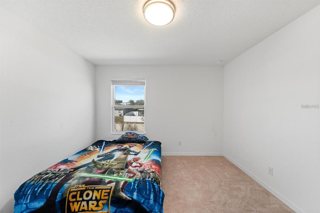 754 Andalusia Loop Davenport, FL 33837 - Photo 17 of 28 a bedroom with a bed and a window