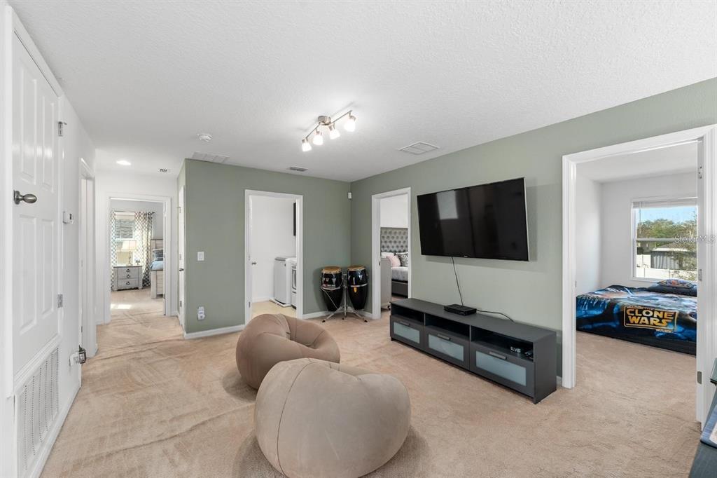 754 Andalusia Loop Davenport, FL 33837 - Photo 18 of 28 a living room with furniture and a flat screen tv