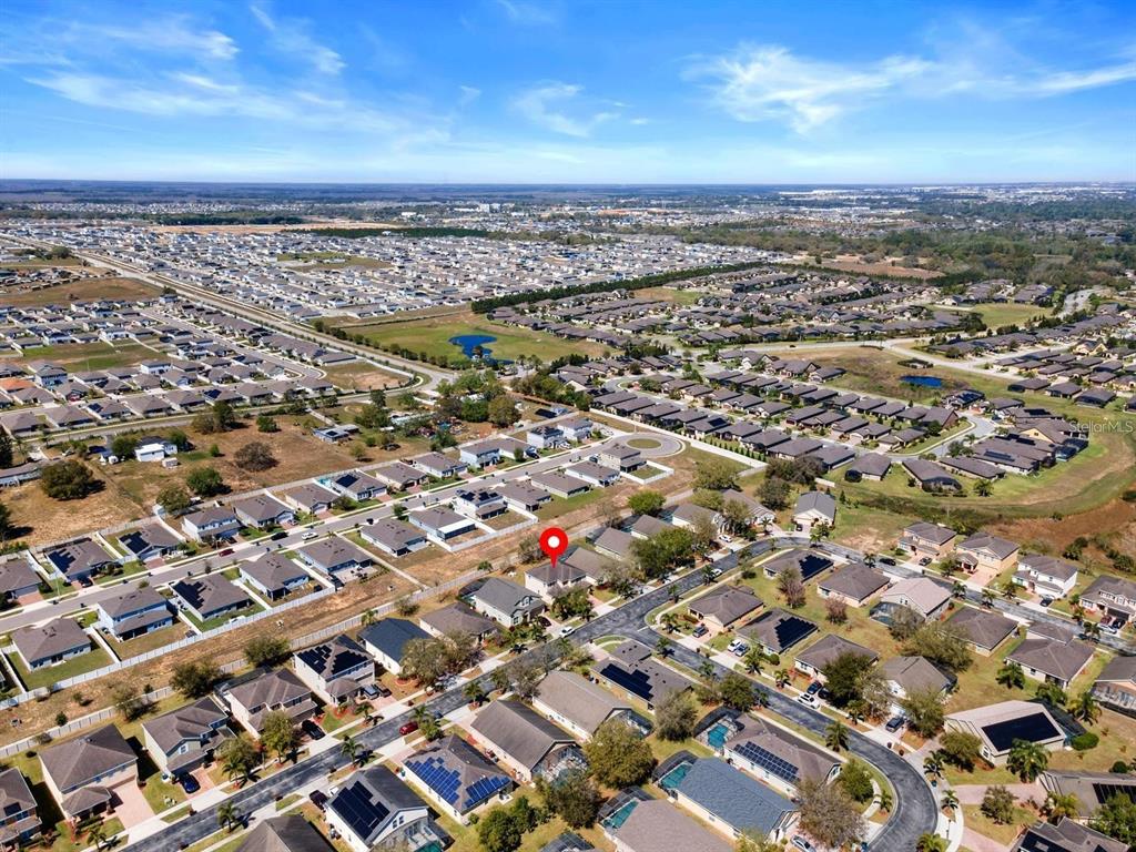 754 Andalusia Loop Davenport, FL 33837 - Photo 26 of 28 an aerial view of a city